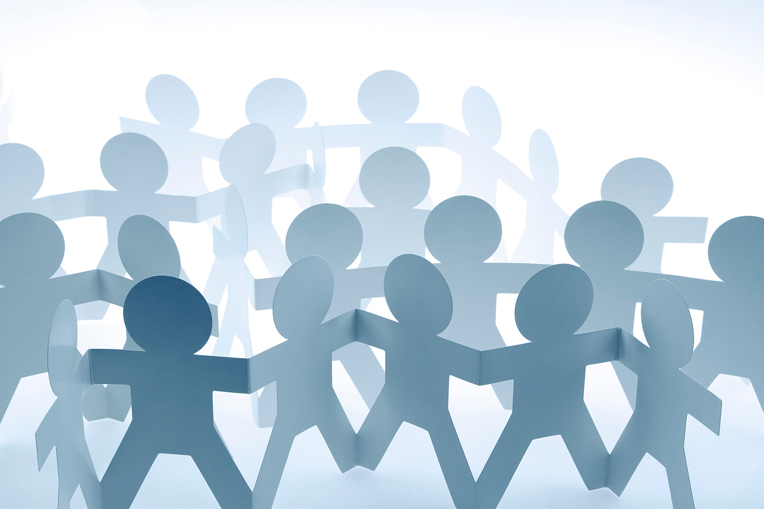 Paper doll people holding hands